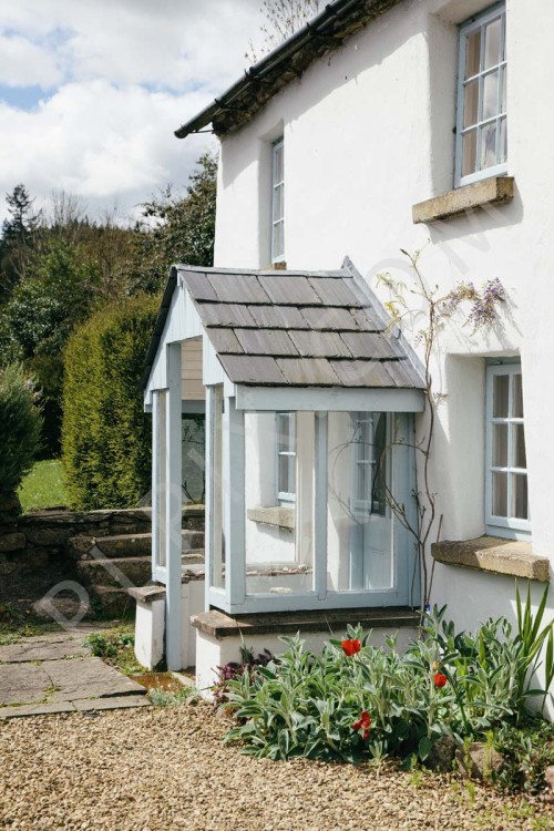 Exterior photography of a long white cottage