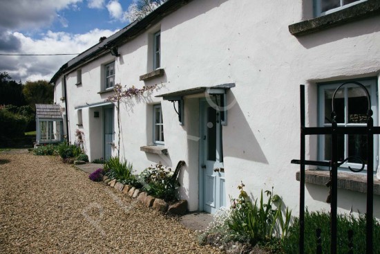 Exterior photography of a long white cottage