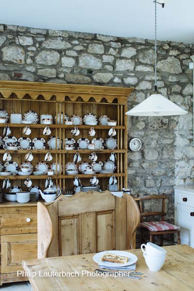 Kitchen area wooden table dresser exposed brick wall storage pendant light