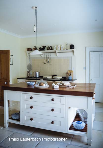 Kitchen area Aga cooker pendant light island with timber top storage shelfing