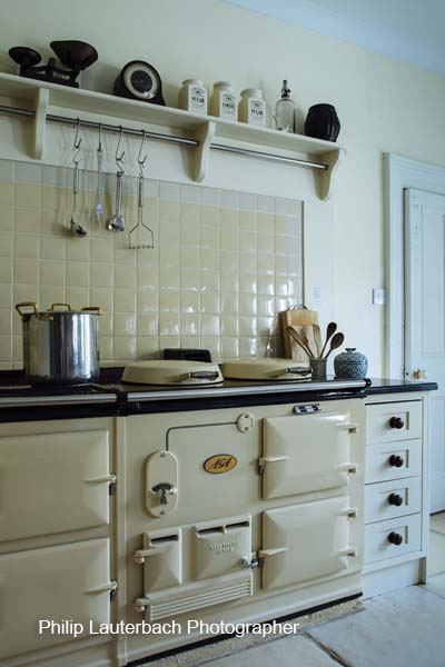 Kitchen area Aga cooker storage shelfing tiling hanging utensils