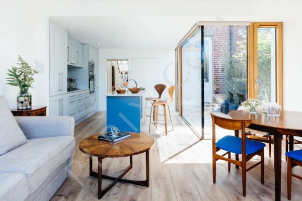 Kitchen restoration and extension with open plan dining and living room glass wall timber flooring side tables