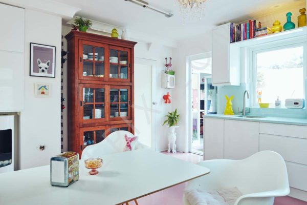 A contemporary retro restoration to a kitchen with a pink floor