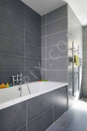 Bathroom floor wall tiling sink mirror bath radiator towel rack glass wall shower