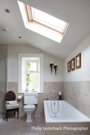 bathroom sink faucet wall mirror tiling shower toilet bathtub skylight