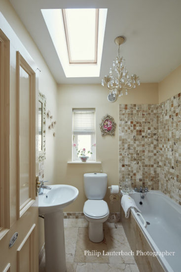 Bathroom wall tiling bath sink chandelier skylight