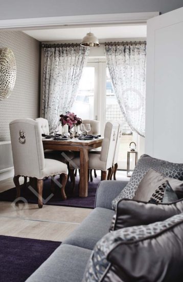 Open plan Dining room wallpaper curtains sofa cushions lighting