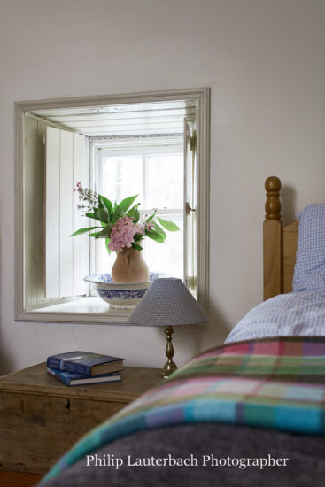 Bedroom detail window sill timber shutters flowers table lamp trunk