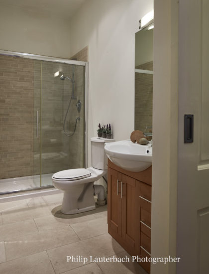 Bathroom floor tiling shower sink wall mirror storage