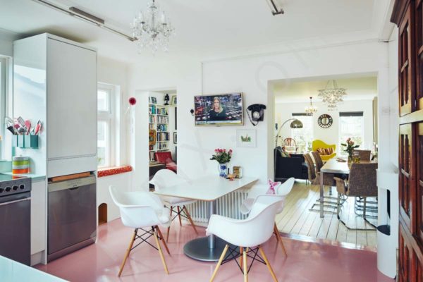 A contemporary retro restoration to a kitchen with a pink floor